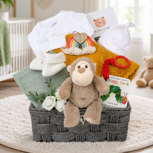Baby gift basket with toys, clothing, and a book with beautiful presentation.