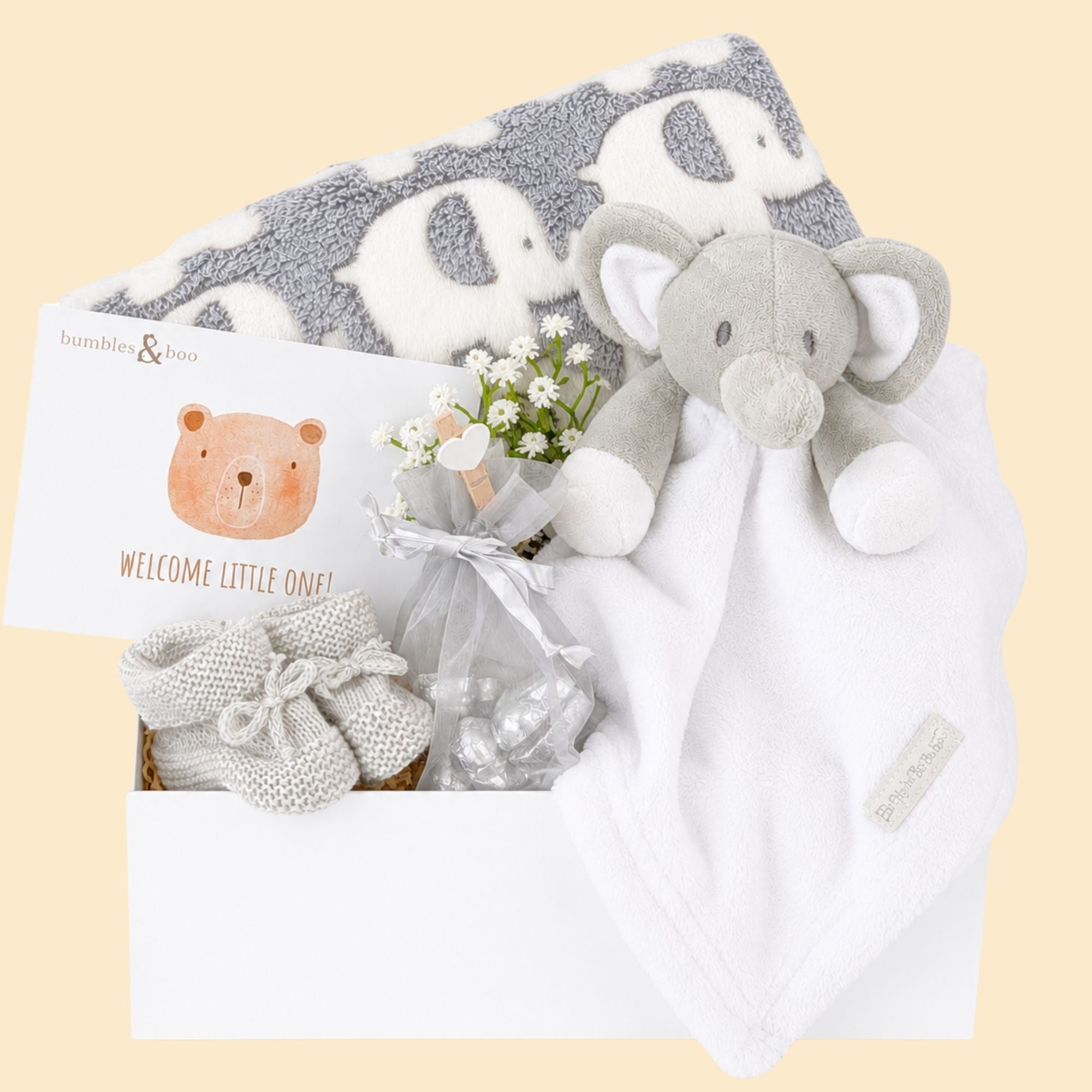 Baby gifts box with a grey elephant blanket and white elephant comforter with a gift for mum.
