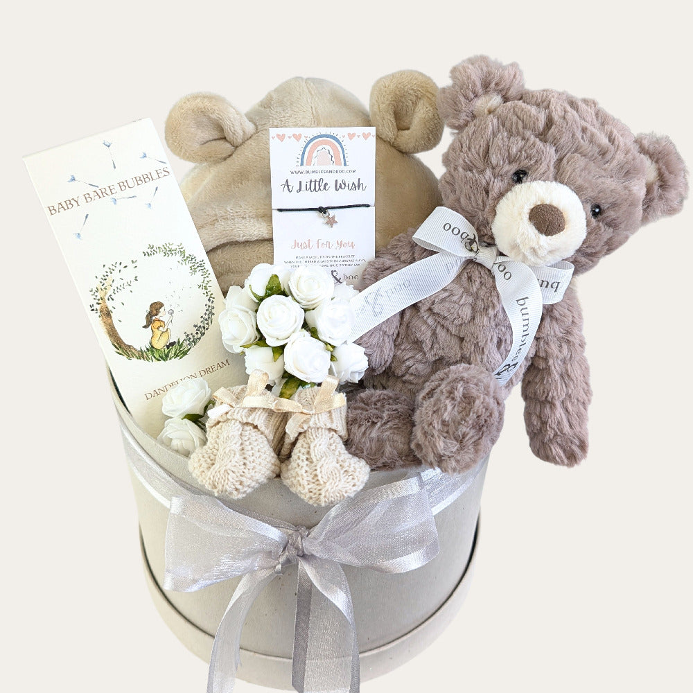 New baby gifts hamper in a hat box with brown teddy and baby bath robe by Bumbles and Boo.