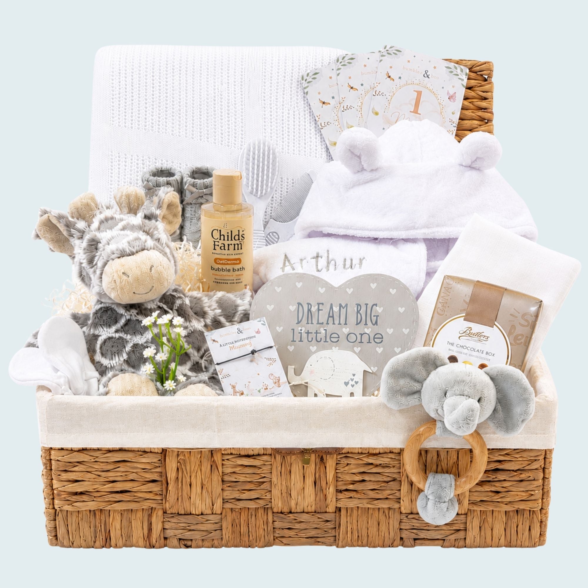 New baby gifts in a hamper basket with giraffe soft toy, baby bath robe and chocolates