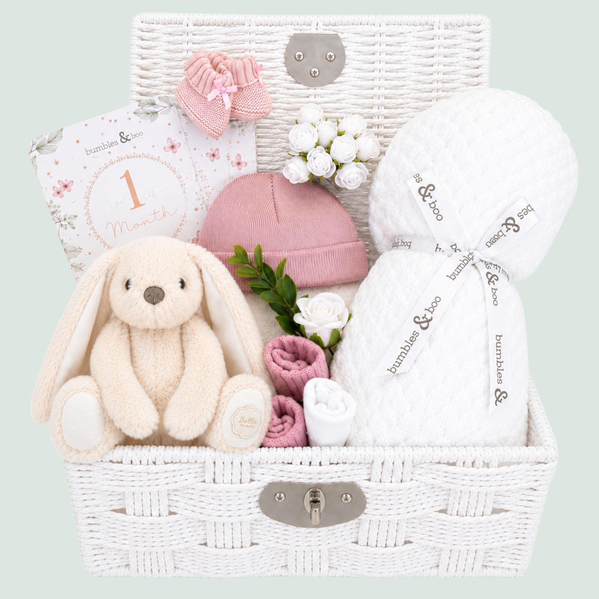 A gift hamper for a baby girl which includes a bunny soft toy and baby blanket plus pink hat and mittens