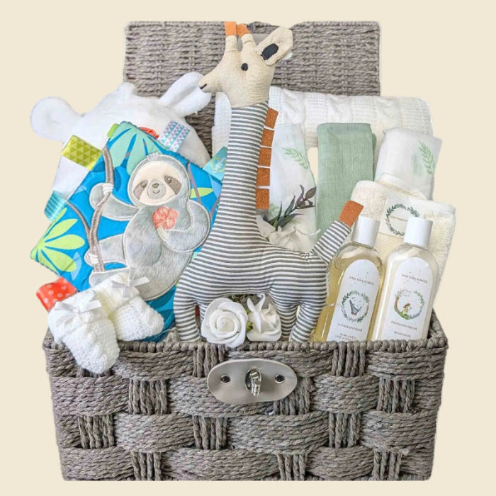 New baby hamper which includes gifts of a baby bath robe, baby knit blanket, set of muslins, organic skincare and some baby toys. Bumbles and Boo.