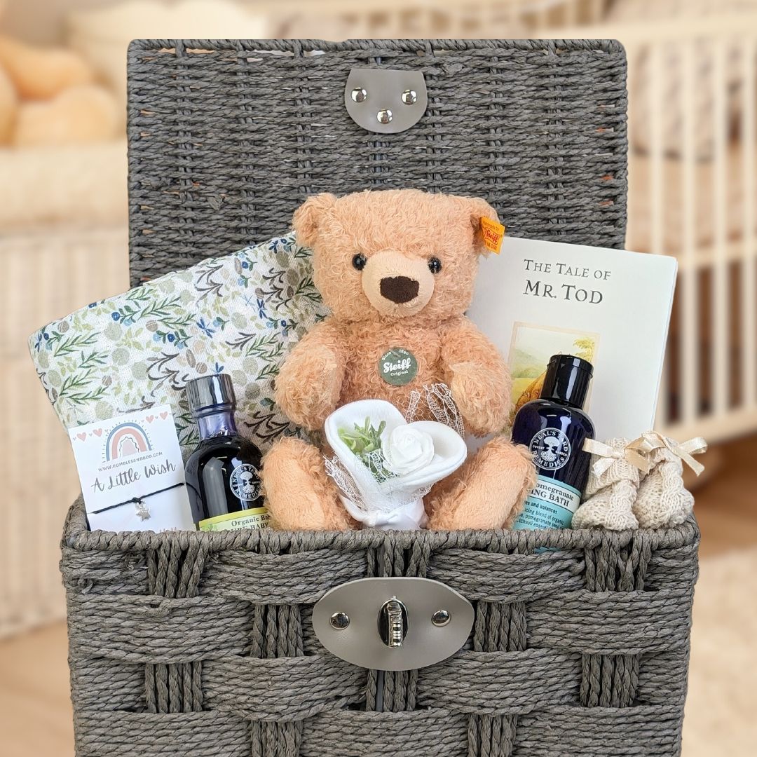 new mum and baby gift hamper with a teddy bear and neals yard remedies