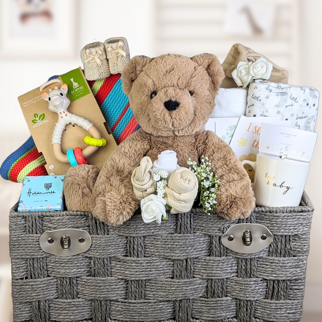 new mum gifts in brown basket with teddy, bracelet, mug, blanket, muslin.