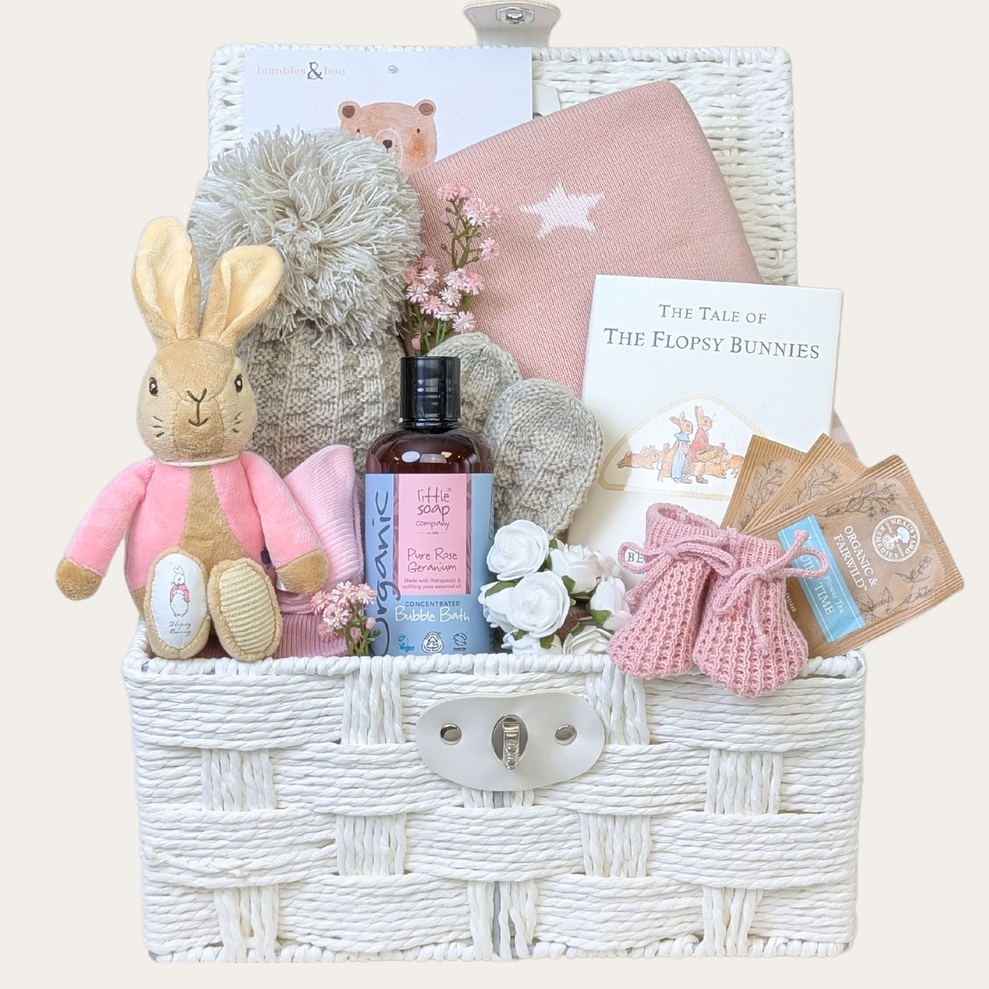 Gifts for a new mum packed in a white hamper basket by Bumbles and Boo.