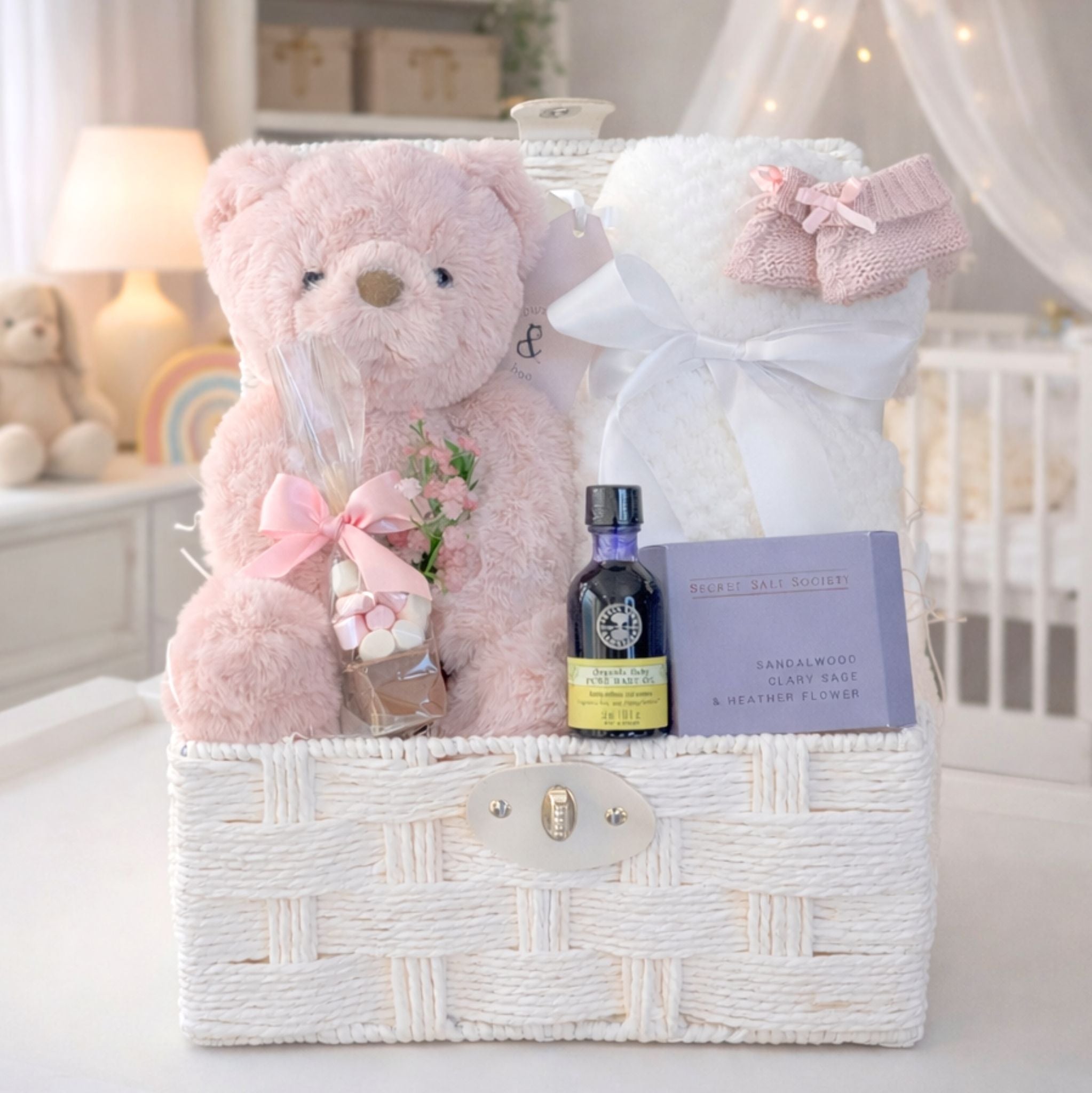 New mum gifts basket with a pink teddy bear and organic neals yard skincare.