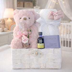 New mum hamper gifts basket with a pink teddy bear and organic neals yard skincare in a white hamper