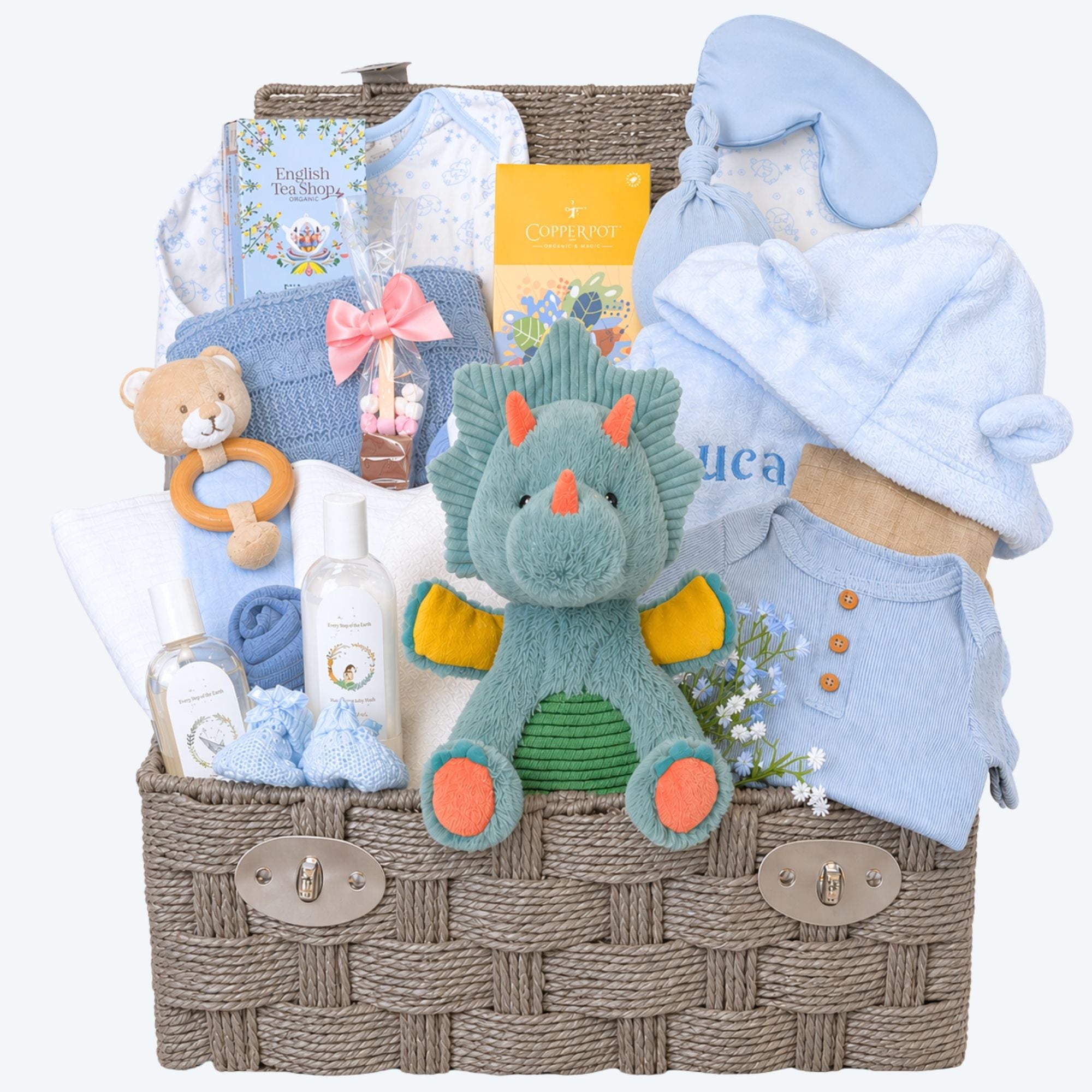 New mum gifts hamper with a dinosaur soft toy and blue baby clothing and bath robe.