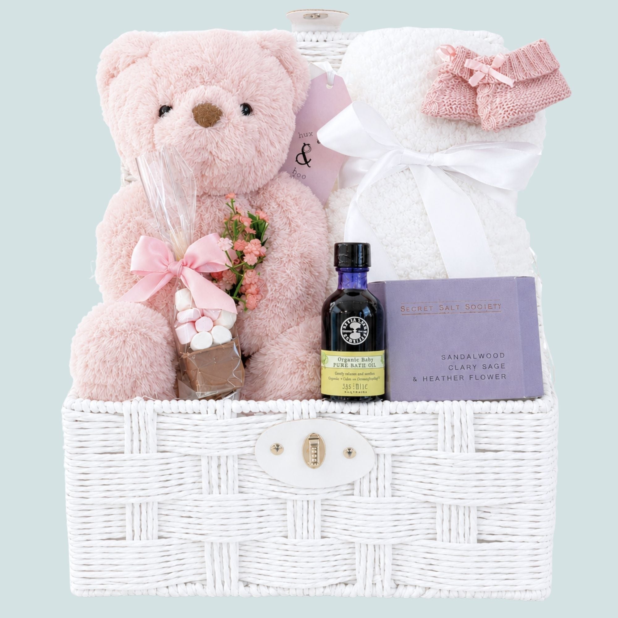 New mum gifts basket with pink teddy bear and white blanket for baby.