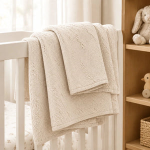 Oatmeal baby cot blanket with grain knit design and fleece-lined reverse