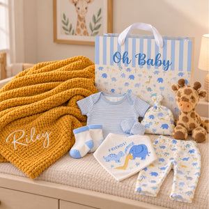 A baby boy gifts set which includes a blue-and-white striped short-sleeve bodysuit, matching booties, a bib with blue elephant and yellow giraffe
