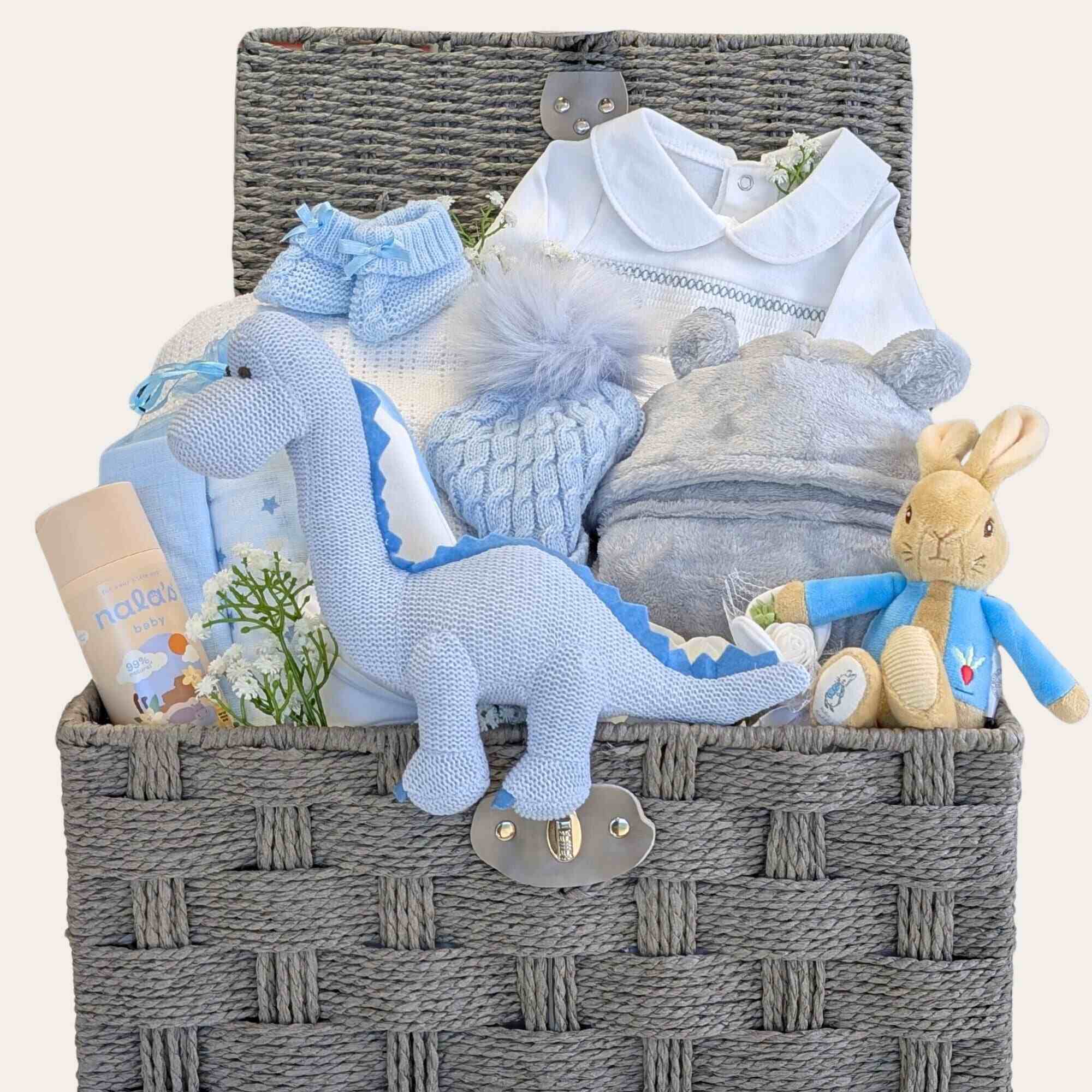Baby boy gifts hamper basket with presents including blue dinosaur newborn toy by Bumbles and Boo.