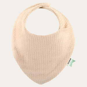 Cocoon Blush bandana bib showing its pale fabric, rounded neckline and pointed front.