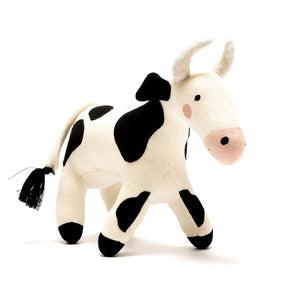 Black and white knitted cow baby toy made from organic cotton with recycled polyester filling