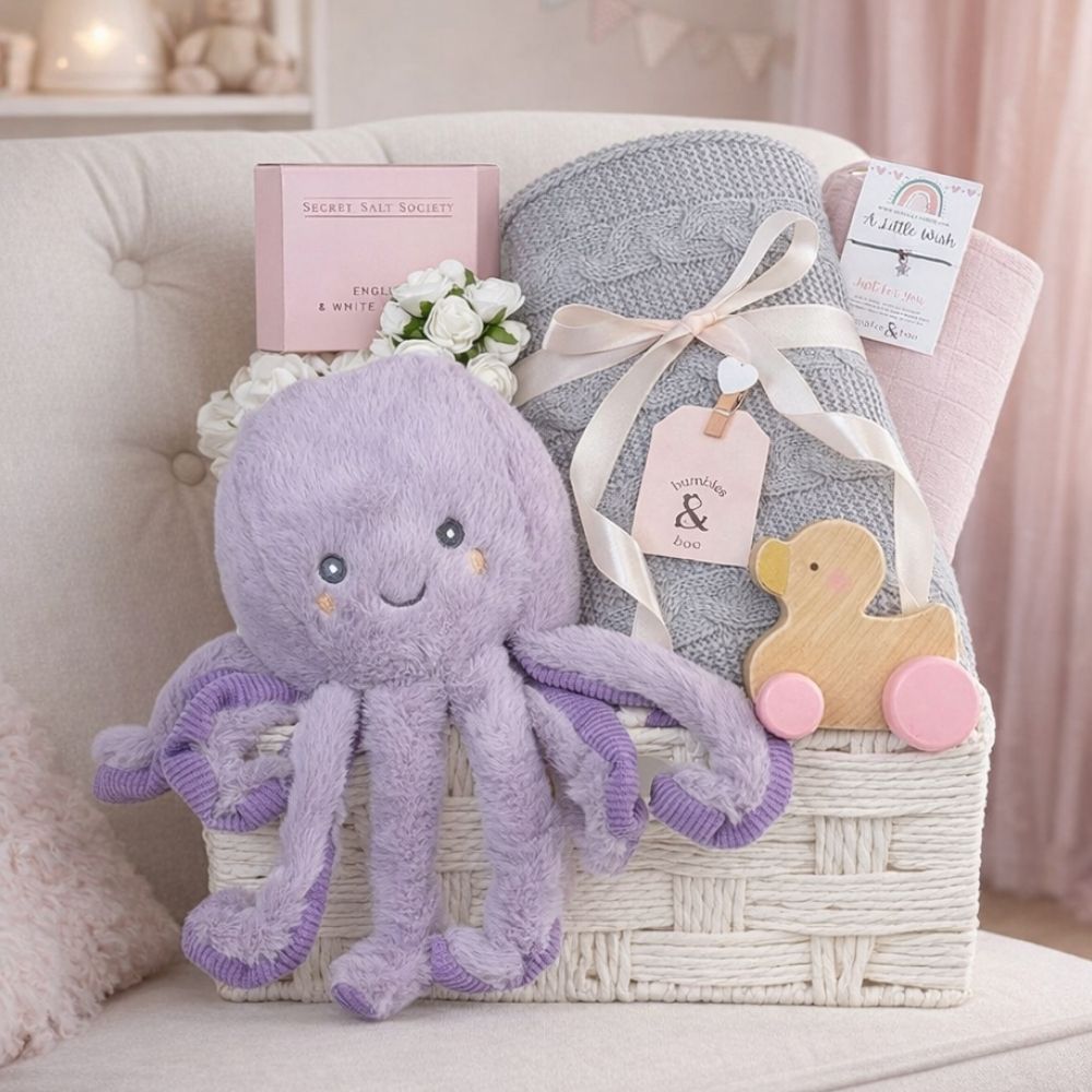 Baby girl gift basket with a purple plush octopus and a grey basket.