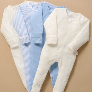 Four pale blue and white baby sleepsuits including a Bear print design