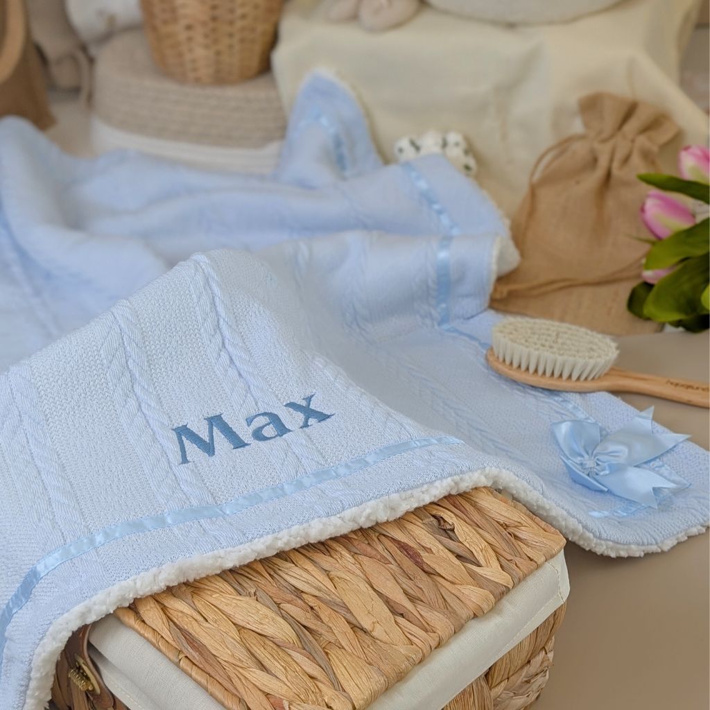Personalised baby blanket in blue with the custom name ‘Max’ embroidered in dark blue