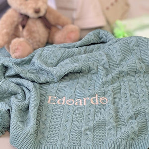 Personalised baby blanket in green knit customised with the name ‘Edoardo’ embroidered across this gift