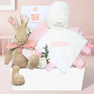 Personalised baby girl gift box by Bumbles and Boo. Presents in this hamper include Flopsy Bunny and pink personalised Millie comforter.