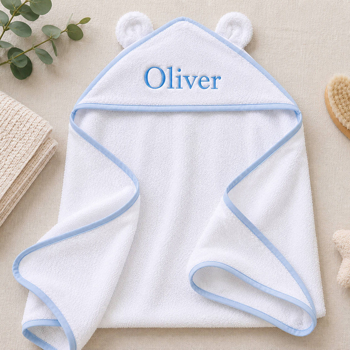 personalised white hooded baby towel with blue trim and bear ears