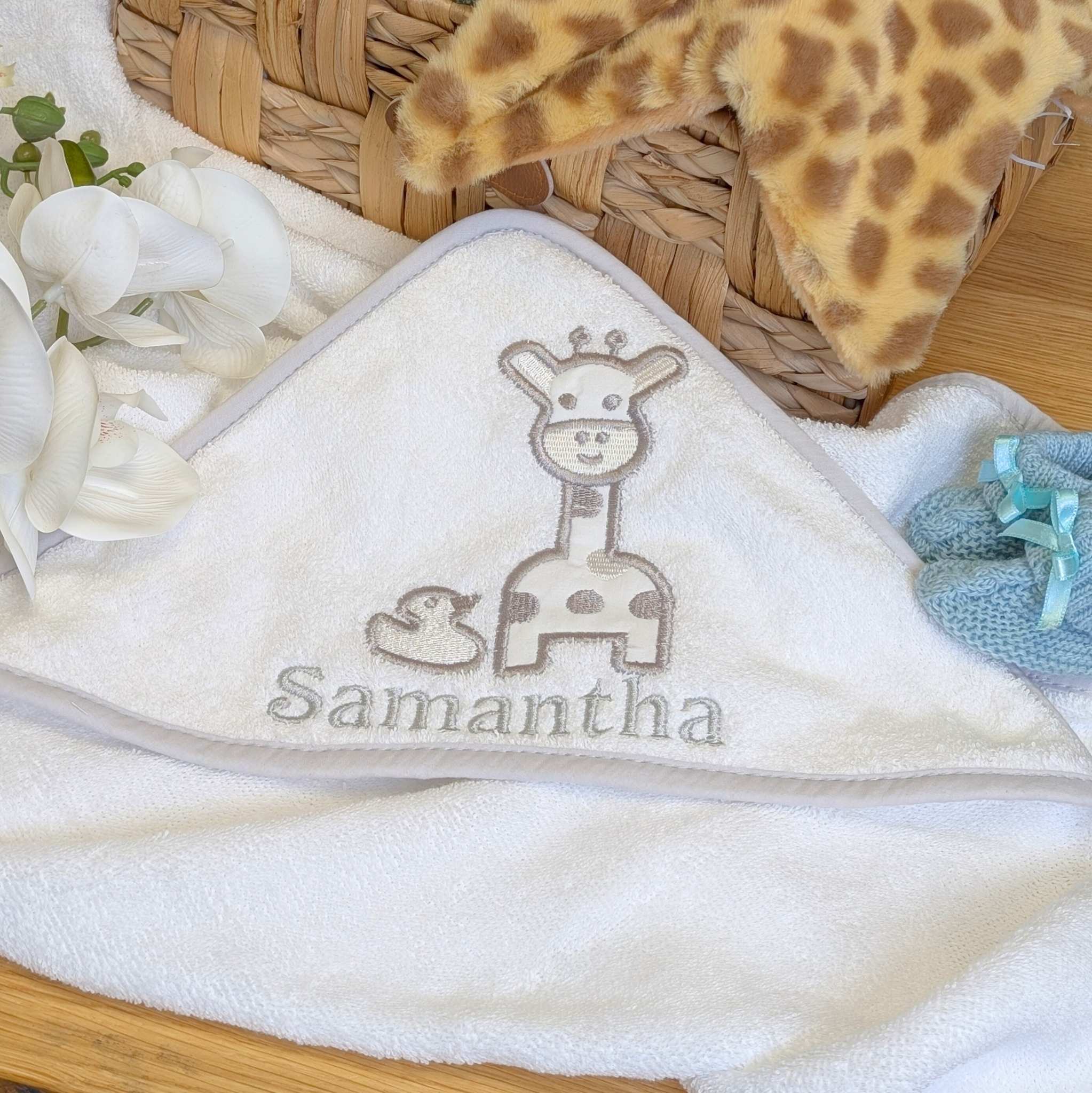 Baby towel with embroidered giraffe and duck design, can be personalised.