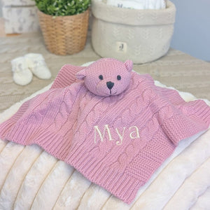 Dusky pink knitted bear comforter with a personalised name.