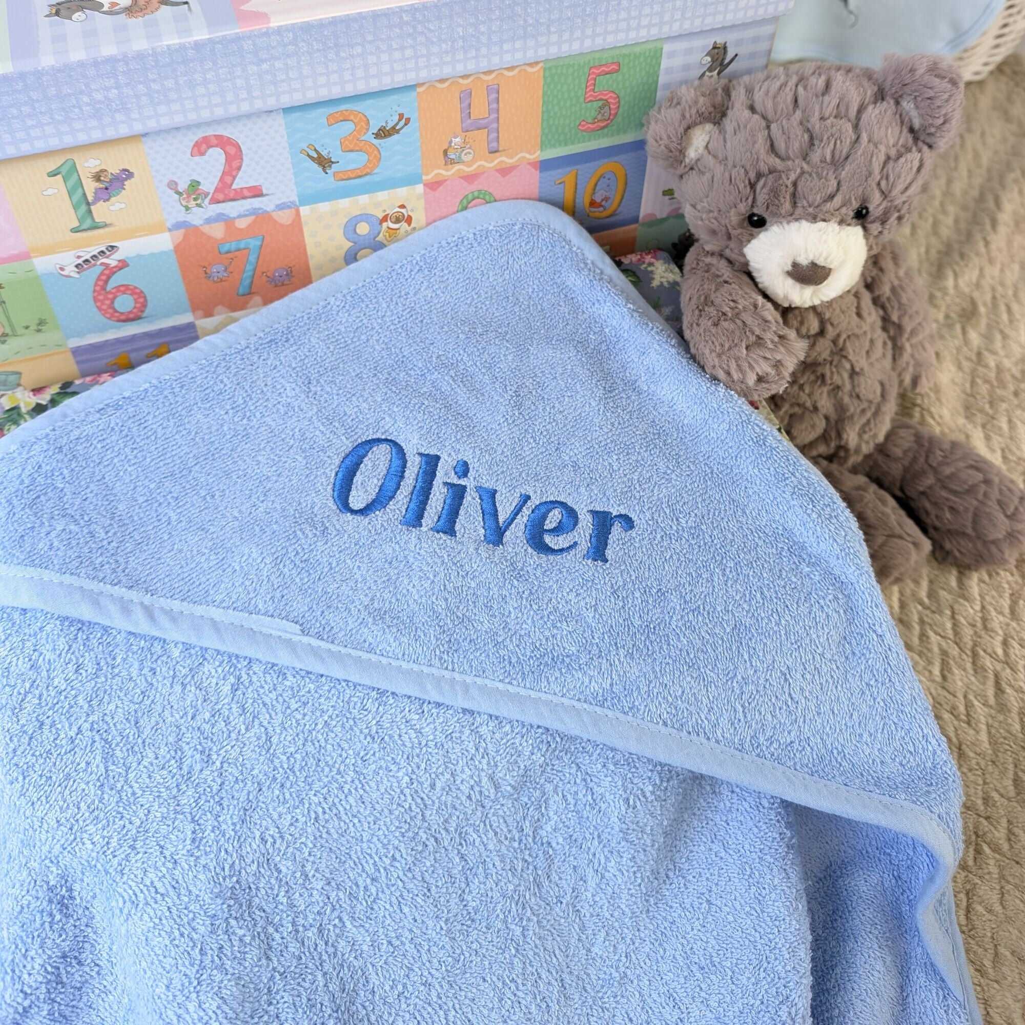 Personalised baby bath towel in sky blue cotton with a custom name embroidered on the hood