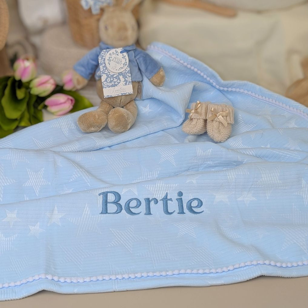 Personalised baby blanket in pale blue with a custom name of Bertie embroidered in dark blue