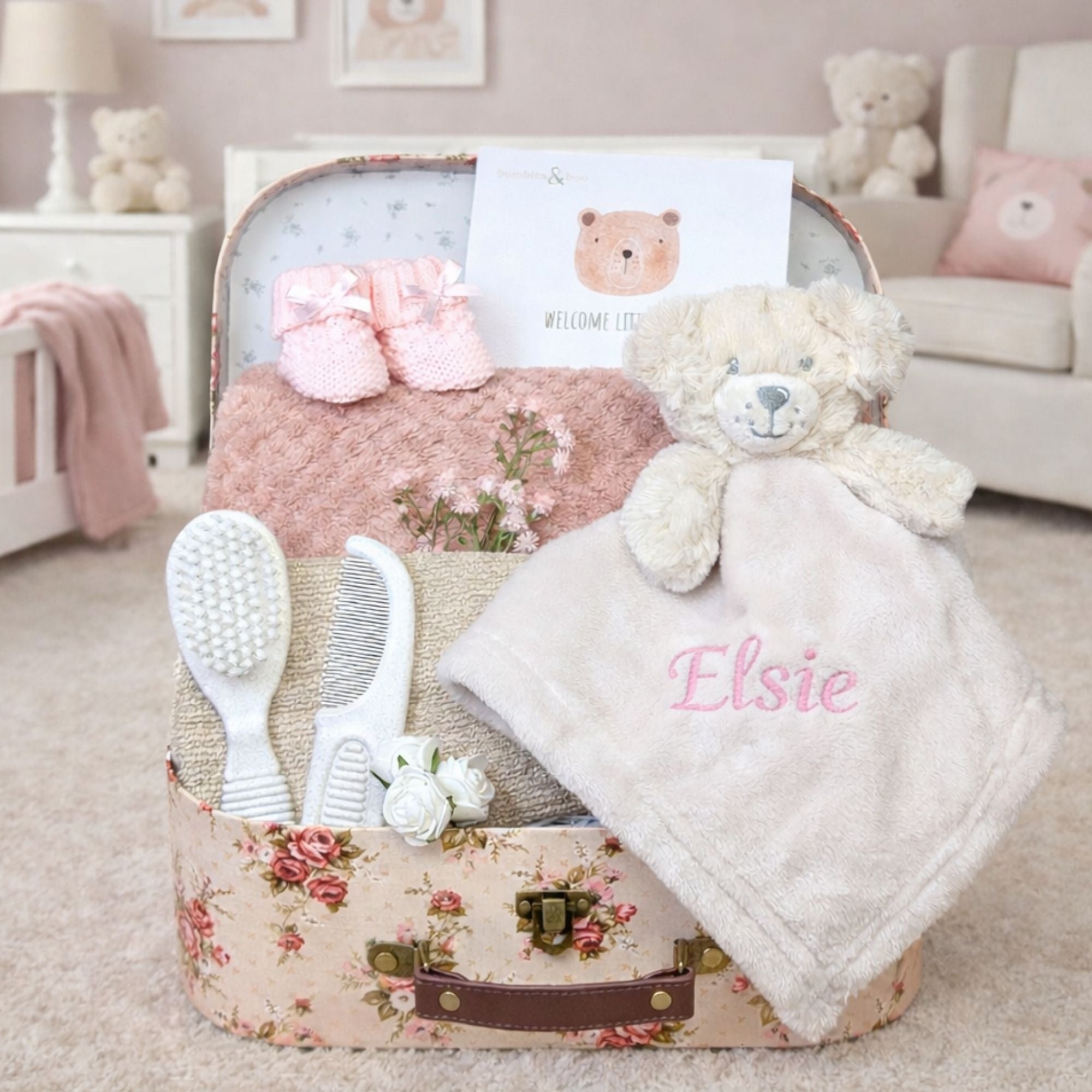 Personalised baby girl hamper gifts in a vintage rose trunk with Elsie embroidered in pink on the comforter