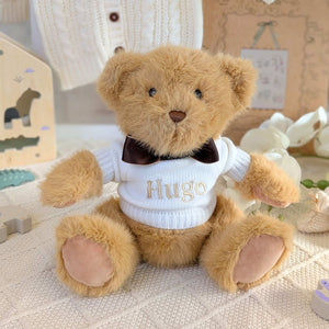 Personalised baby teddy bear with cream jumper embroidered with the name Hugo