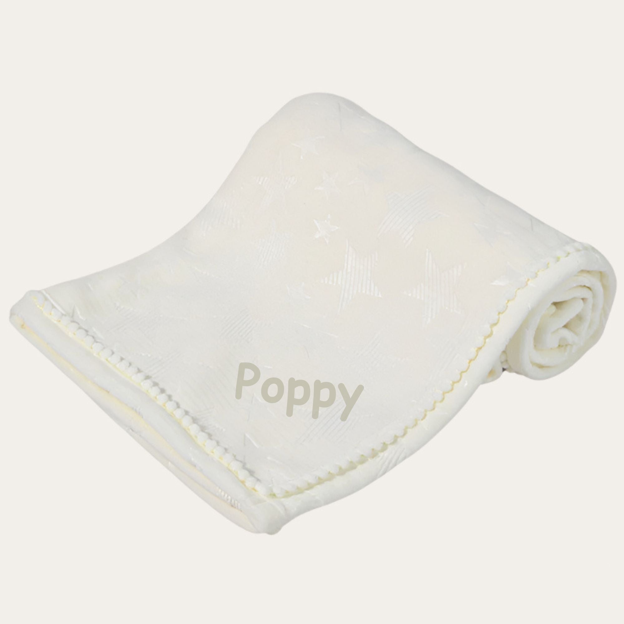 A personalised white baby blanket with a star design and little pompoms.