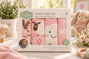 Boxed set of four pink bandana bibs showing woodland, sheep and cloud designs through the front window.