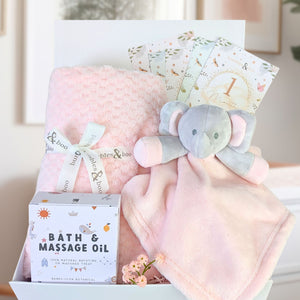 Pink blanket and elephant comforter present for a baby shower.