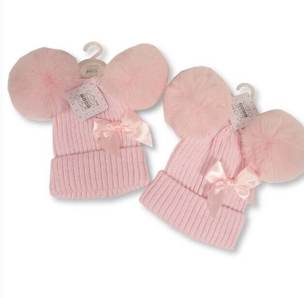 Pink knitted hat with two pom poms and a bow