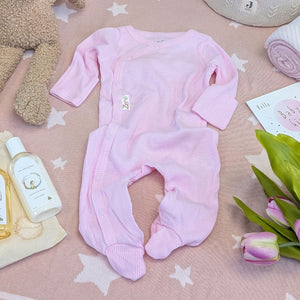 Pink baby girl sleepsuit with poppers and made from recycled cotton.