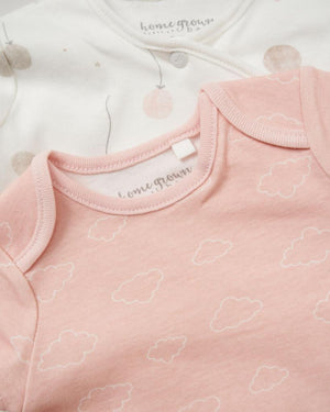 Picture of pink short sleeve vest with cloud pattern and white long sleeve baby grow with balloon print