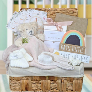 Pregnancy gift basket with nursery plaque and teddy bear comforter.