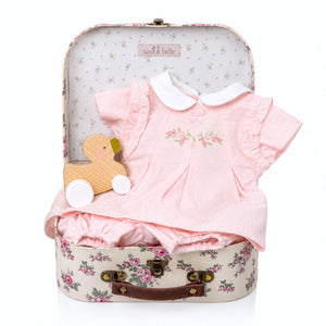 Baby girl gifts hamper with floral baby clothing and a wooden push along duck