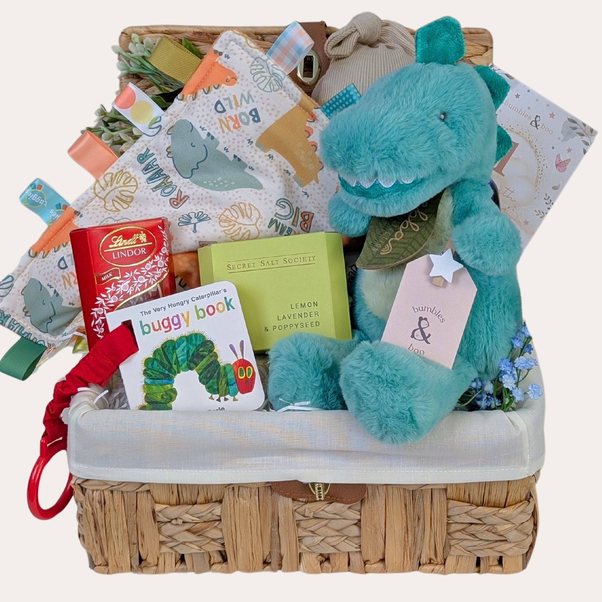 New baby boy gifts hamper basket full of presents including plush dragon toy and dinosaur taggie. Bumbles and Boo.