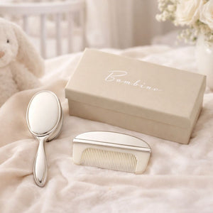 Silver brush and comb keepsake for a baby in a gift box.