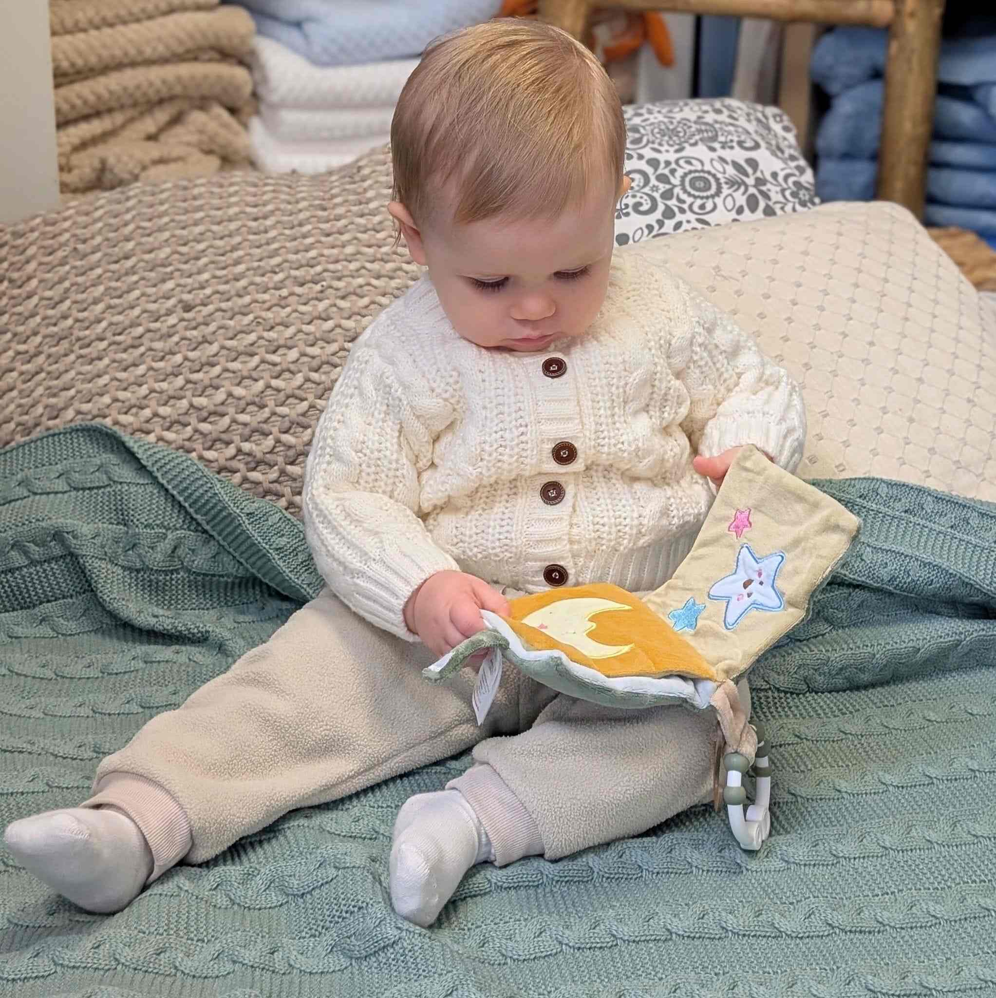 A soft activity book with a teether