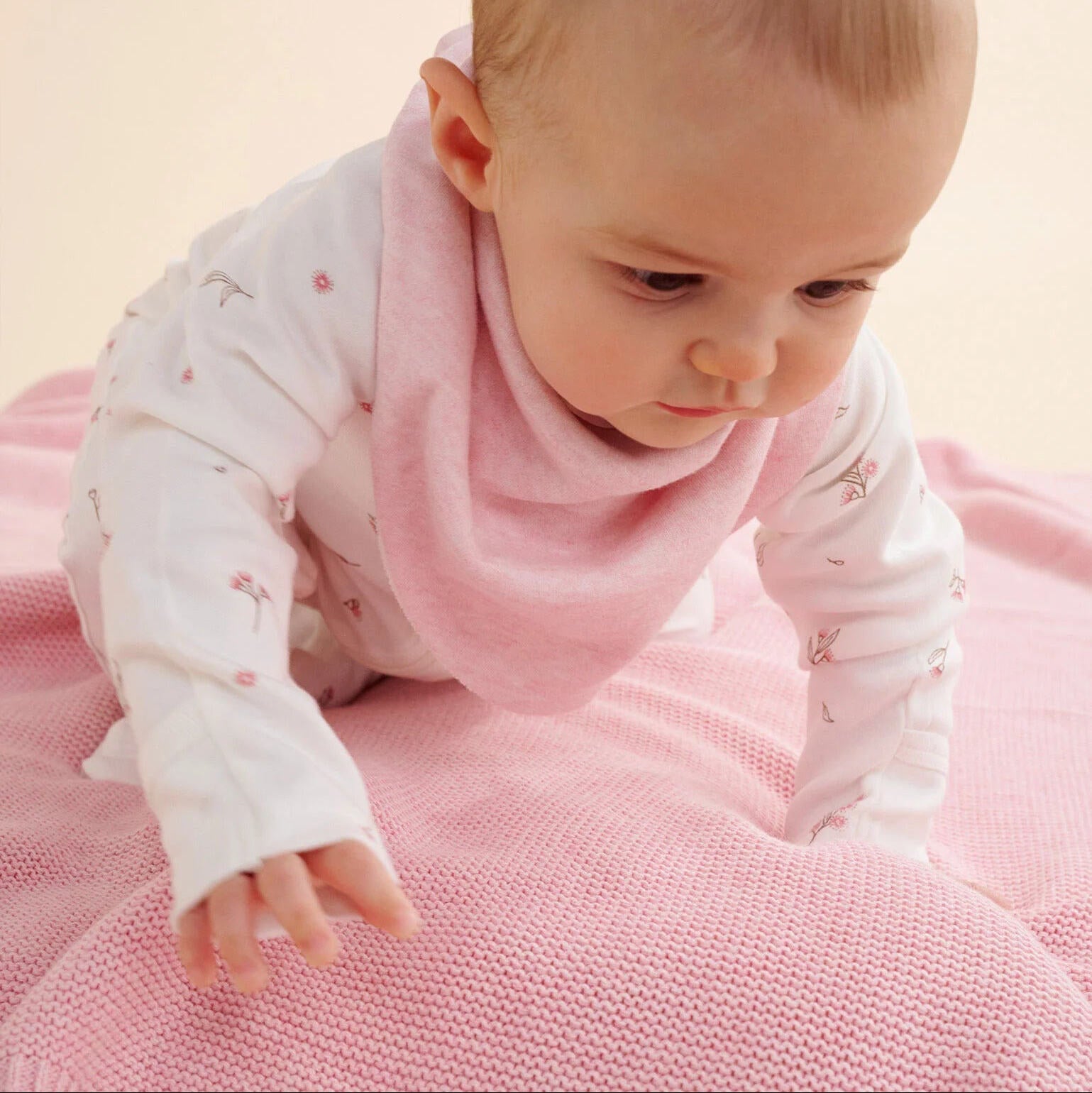 Soft pink organic cotton baby blanket with ribbed trim