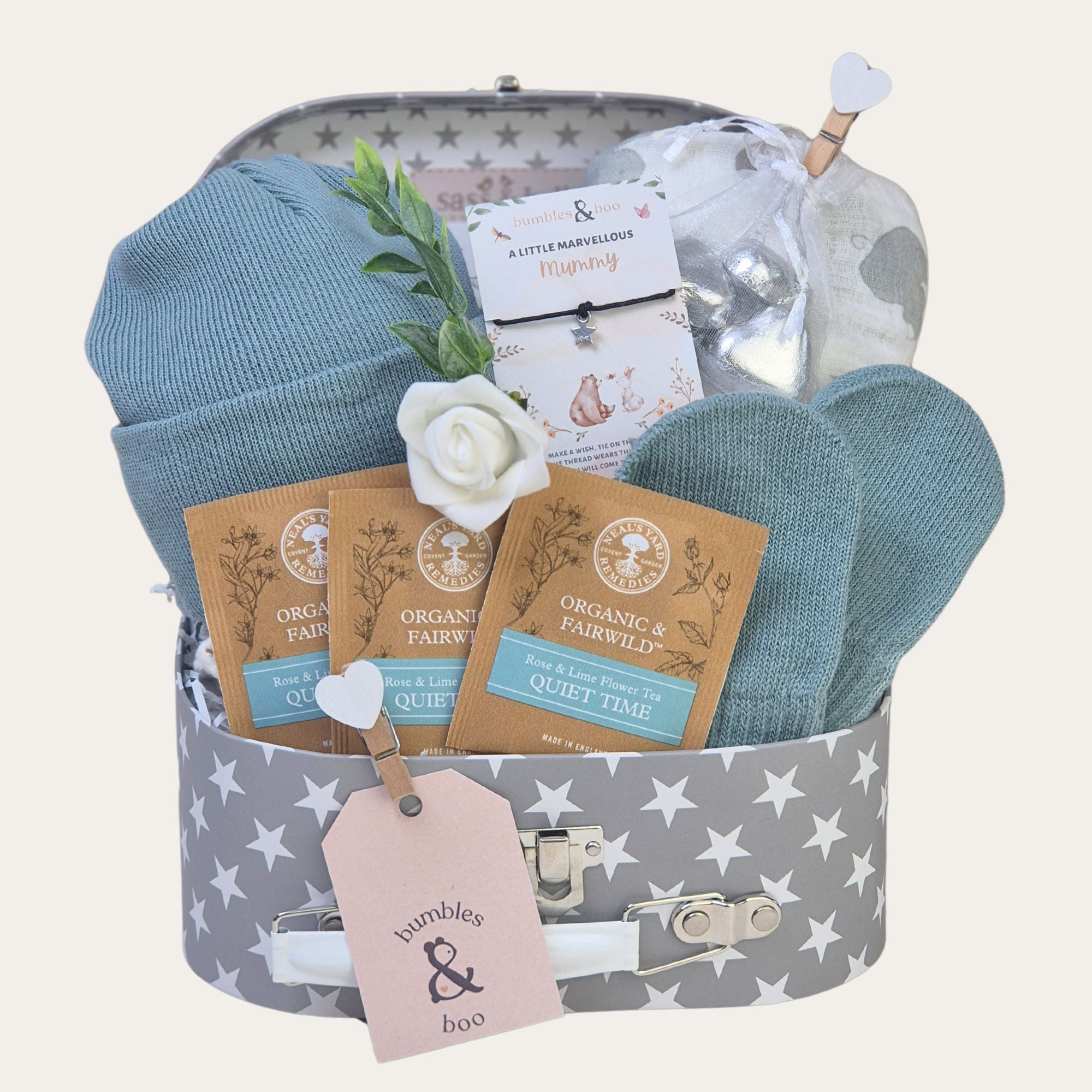 New baby boy gifts hamper with sage green hat and mittens and other presents in a hamper box.