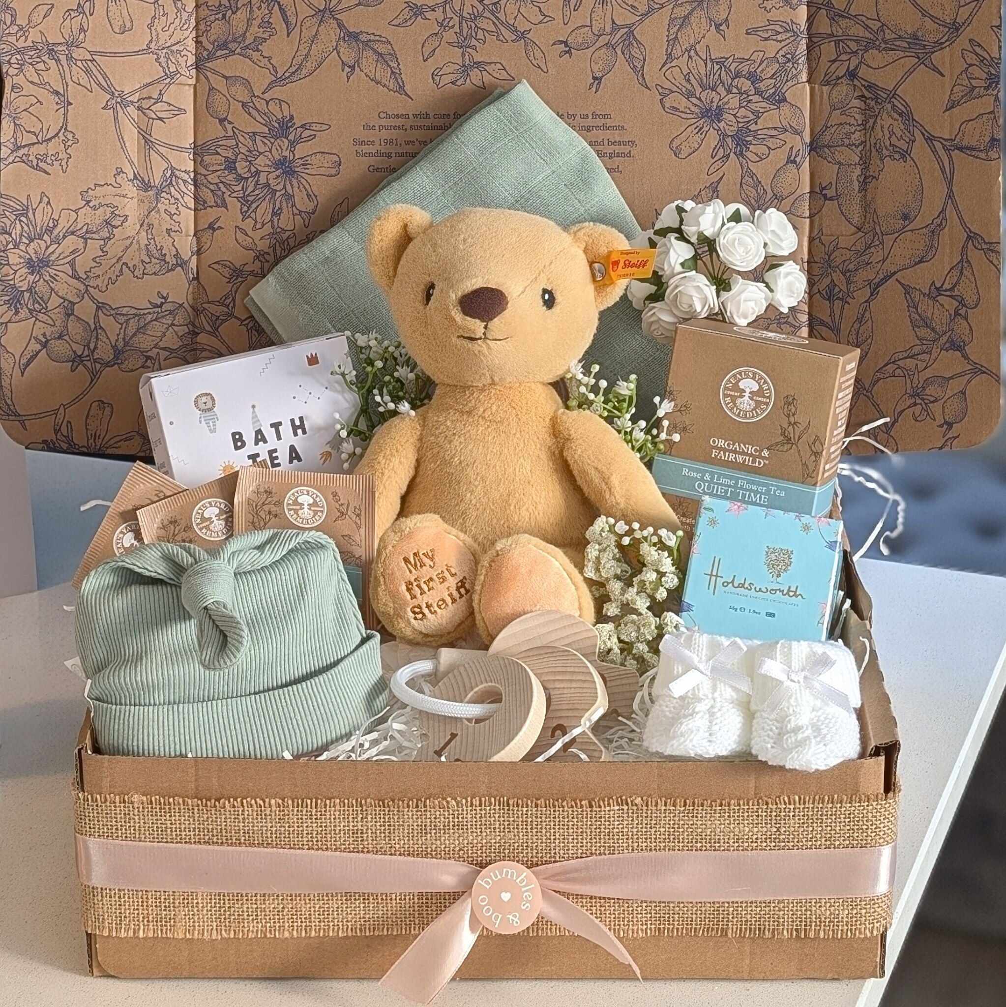 New baby hamper gifts box with steiff teddy bear and sage green baby clothes by Bumbles and Boo.