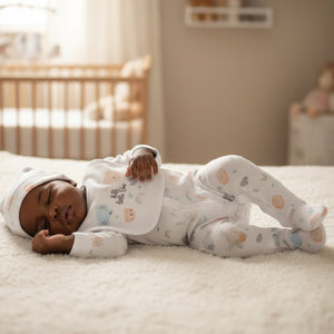 Baby wearing unisex animals sleepsuit, bib and hat from a 5 piece clothes set