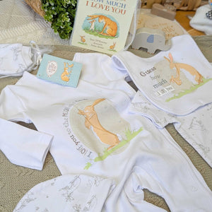 Baby clothing set with sleepsuit, vest, bib, hat and mittens.