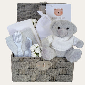 Baby gifts hamper basket for a new born with white and grey presents designed by Bumbles and Boo.