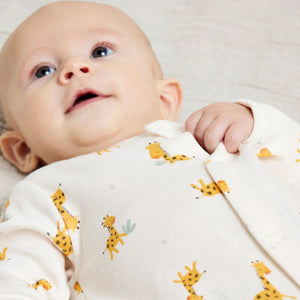 Unisex baby clothes styled as a complete outfit in soft multicolour tones