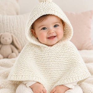 White knitted baby poncho for 3-6 months with hood and pom-pom detail