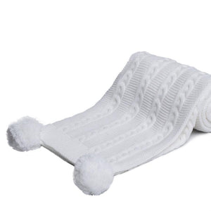 white soft pom pom blanket. Made from recycled materials.